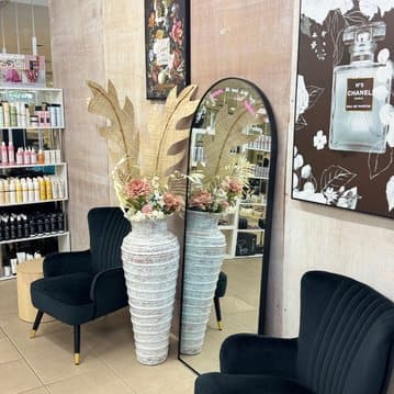 The salon's retail corner and arch mirror